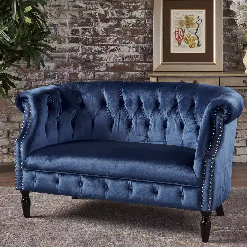 Divanetto 2 posti capitonné con braccioli arrotolati nei colori mora / smeraldo / blu navy