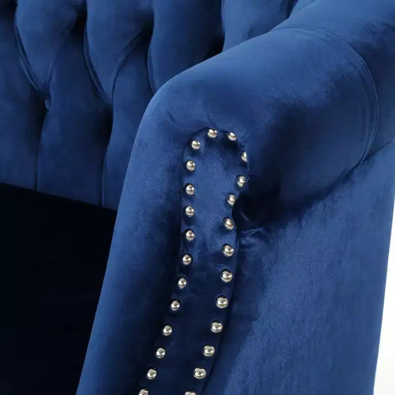 Divanetto 2 posti capitonné con braccioli arrotolati nei colori mora / smeraldo / blu navy
