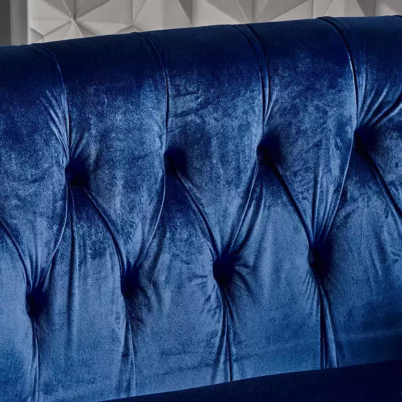 Divanetto 2 posti capitonné con braccioli arrotolati nei colori mora / smeraldo / blu navy